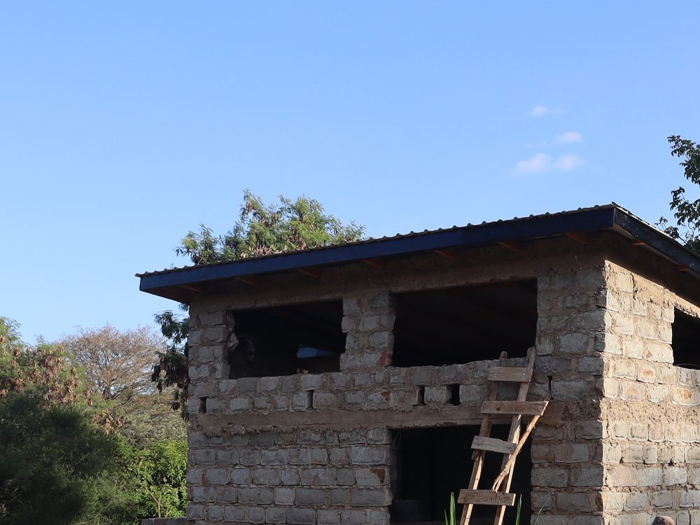 Stone wall construction in progress on a Kenyan site